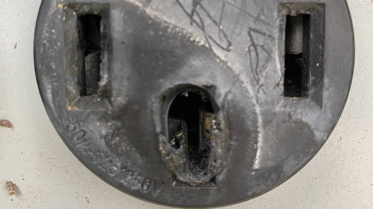 A melted 50A electrical outlet on a campground pedestal.