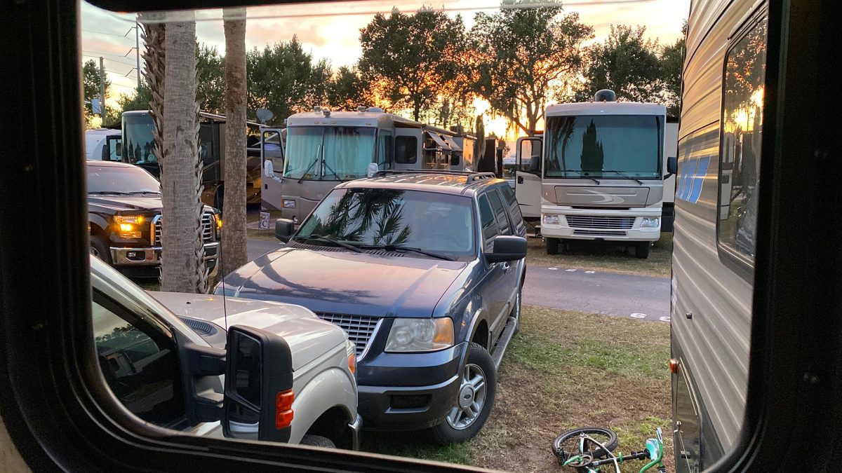 Looking out a camper window at an overpopulated Florida campground.