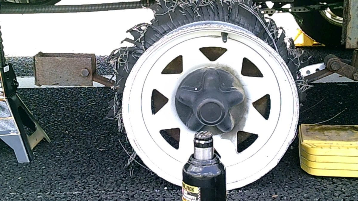 A shredded camper tire while towing, and a cracked camper frame.